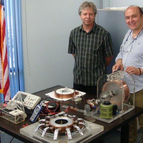 Two men beside the table with SEG models